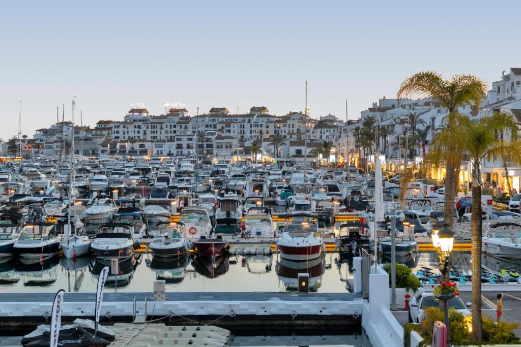 Puerto Banús marina at dusk with luxury yachts and waterfront restaurants Marbella