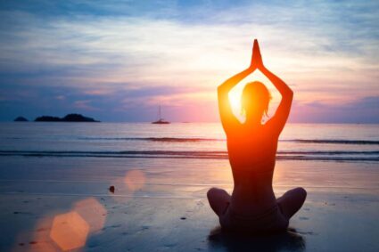 Group beach yoga session at sunrise in San Pedro, Marbella