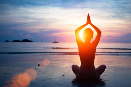 Group beach yoga session at sunrise in San Pedro, Marbella